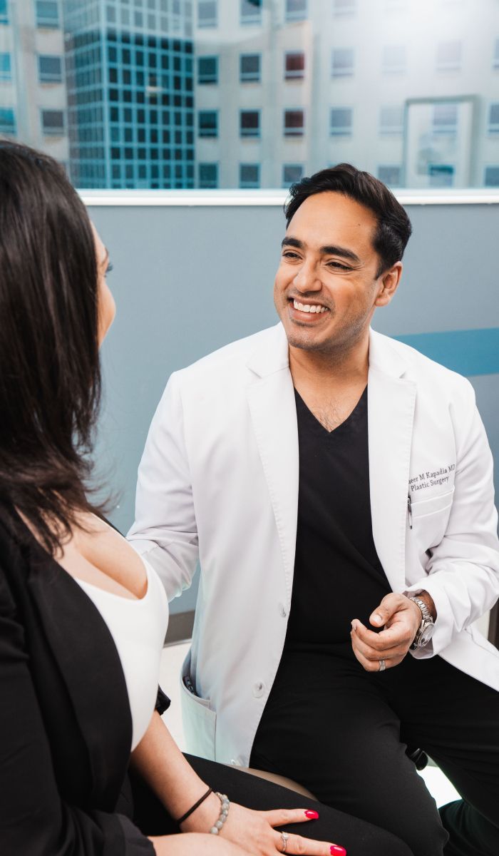 Chicago plastic surgeon, Dr. Sameer Kapadia, consulting with a patient