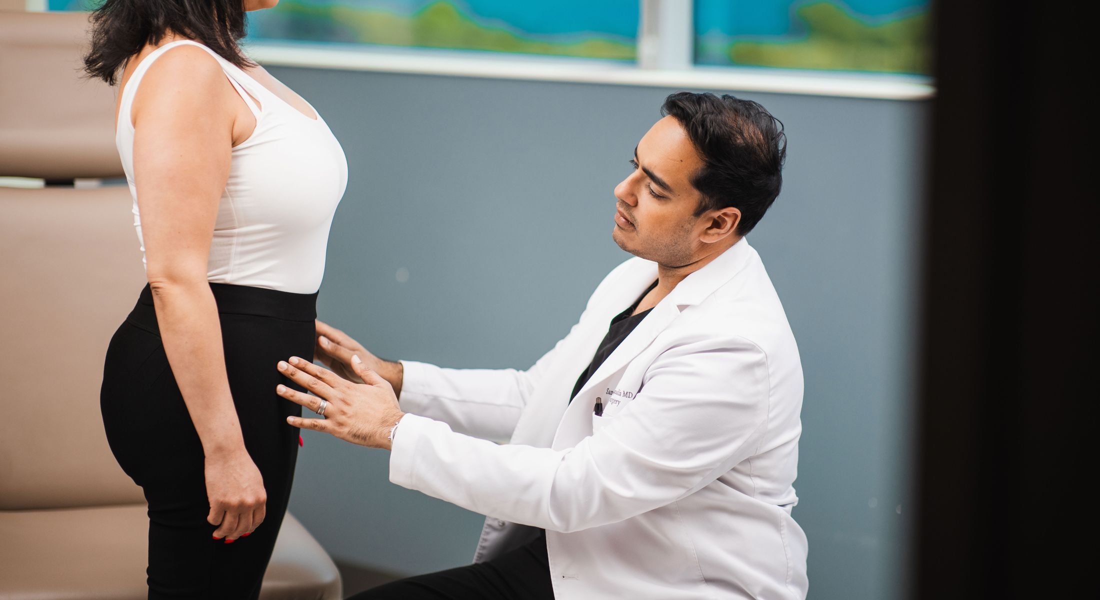 Medical consultation focusing on woman's abdomen.