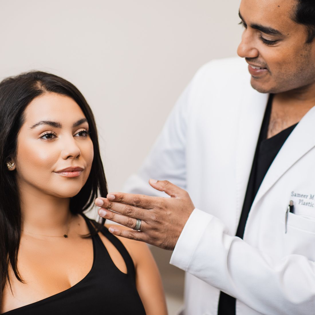 Chicago plastic surgeon, Dr. Sameer Kapadia consulting with a patient.