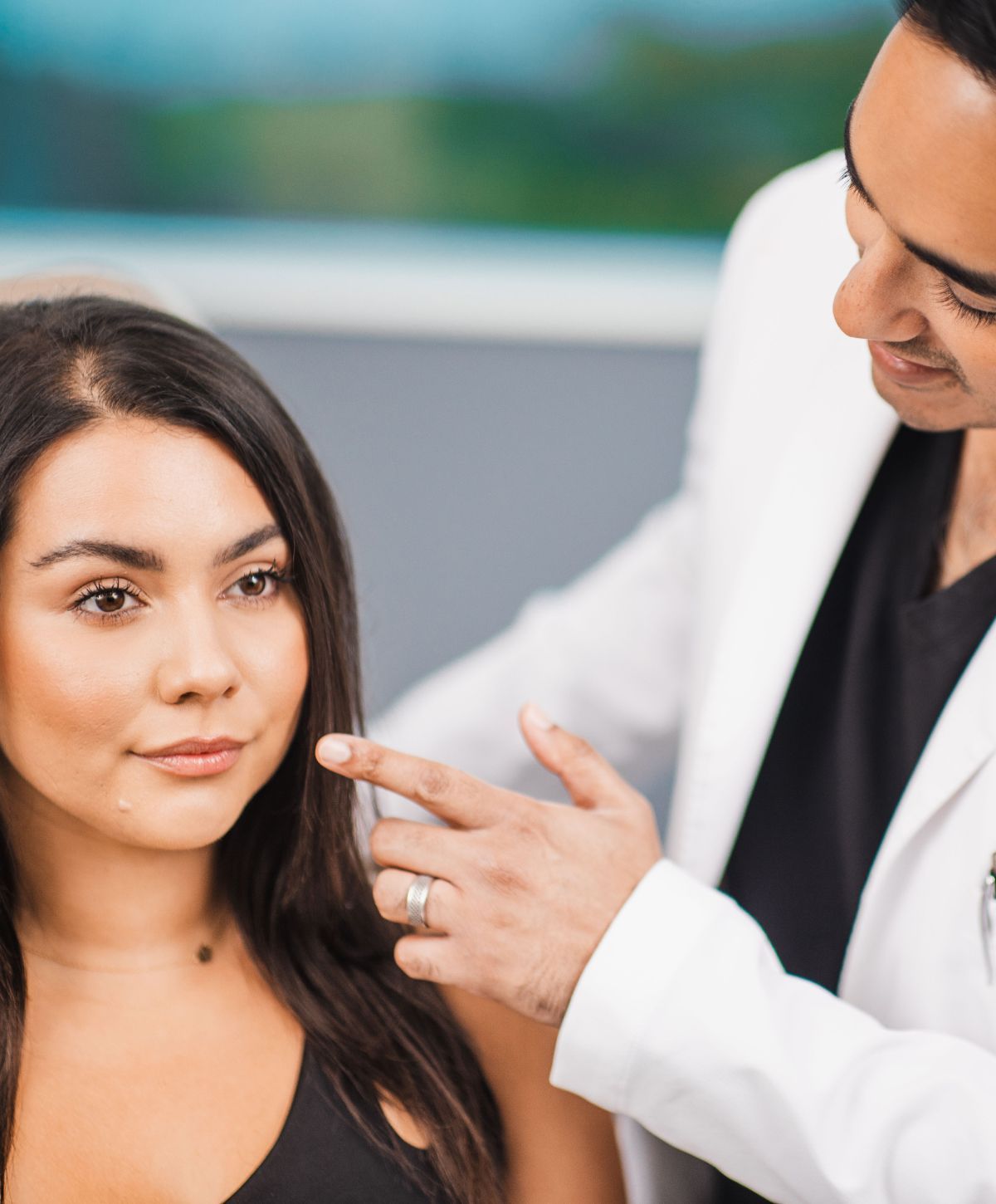 Chicago plastic surgeon, Dr. Kapadia, consulting with a med spa patient