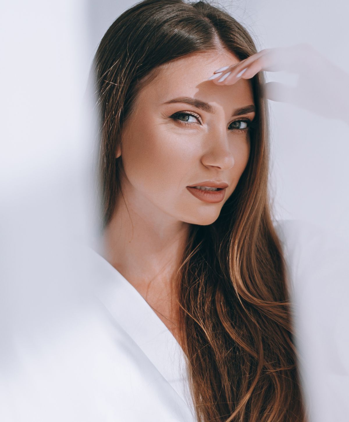 Woman posing with long hair and thoughtful expression.