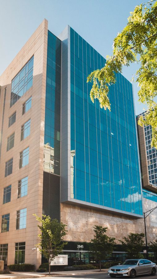 Modern office building with reflective glass exterior.