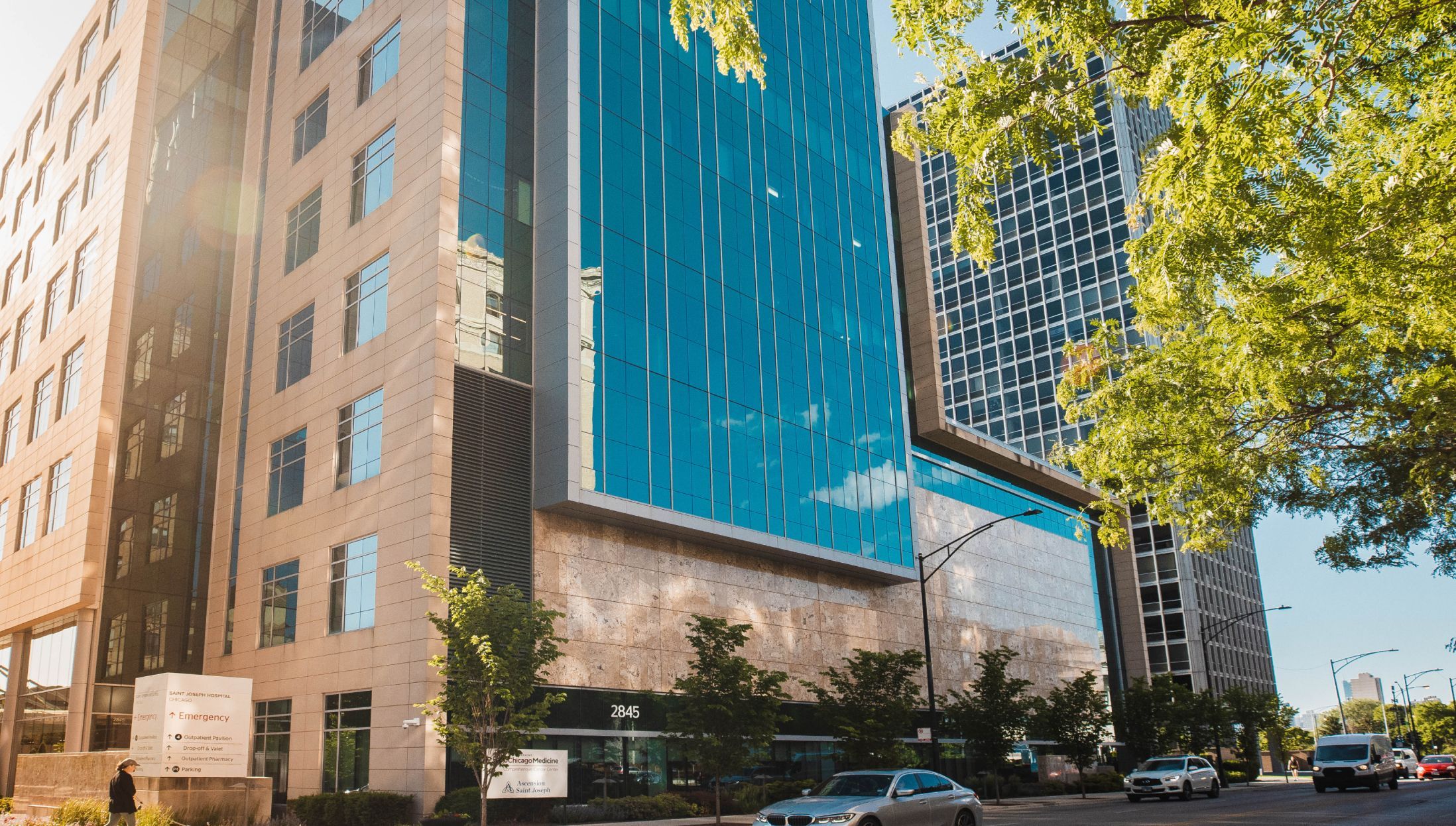 Modern hospital building with glass exterior.